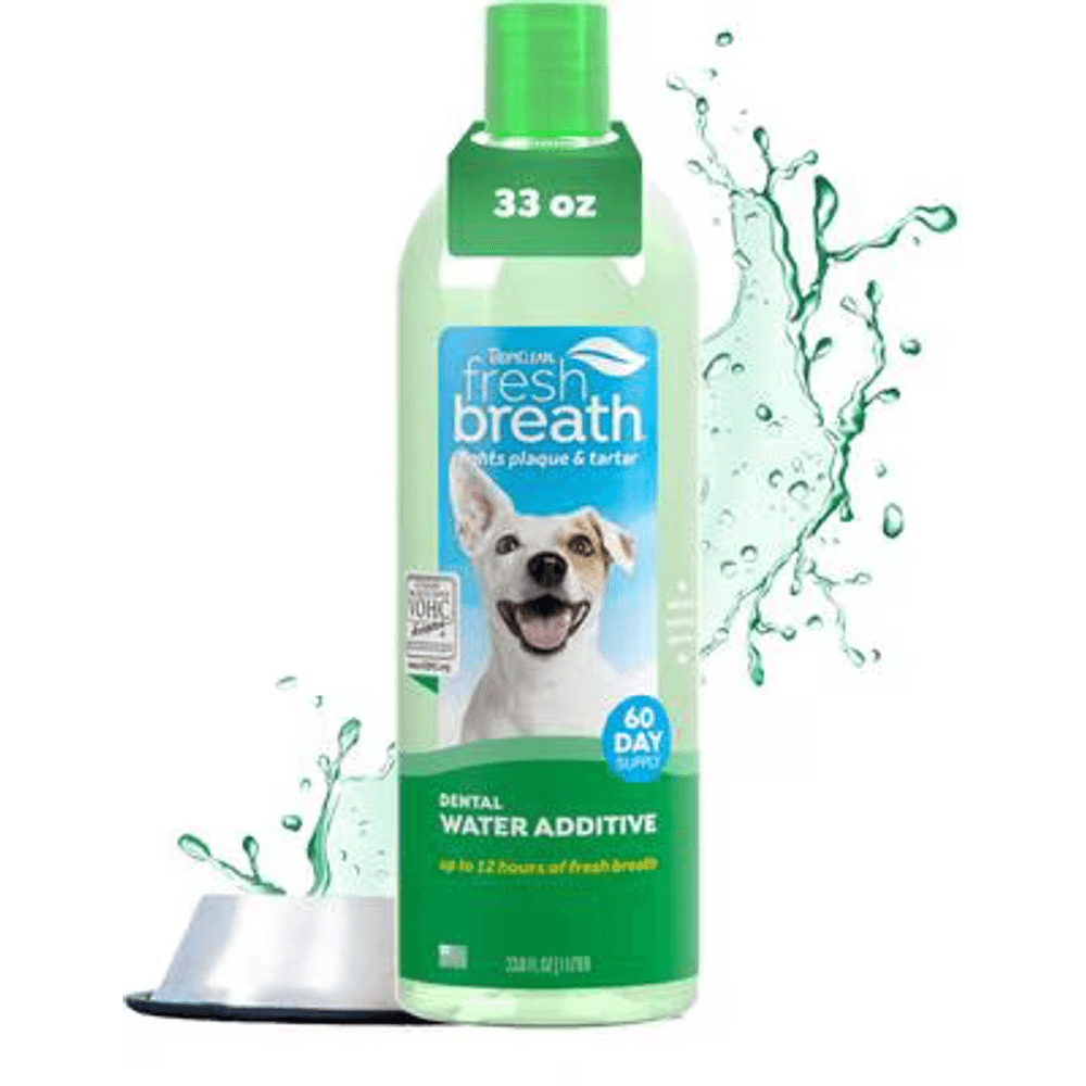 TropiClean Fresh Breath dental water additive bottle for dogs beside a water bowl