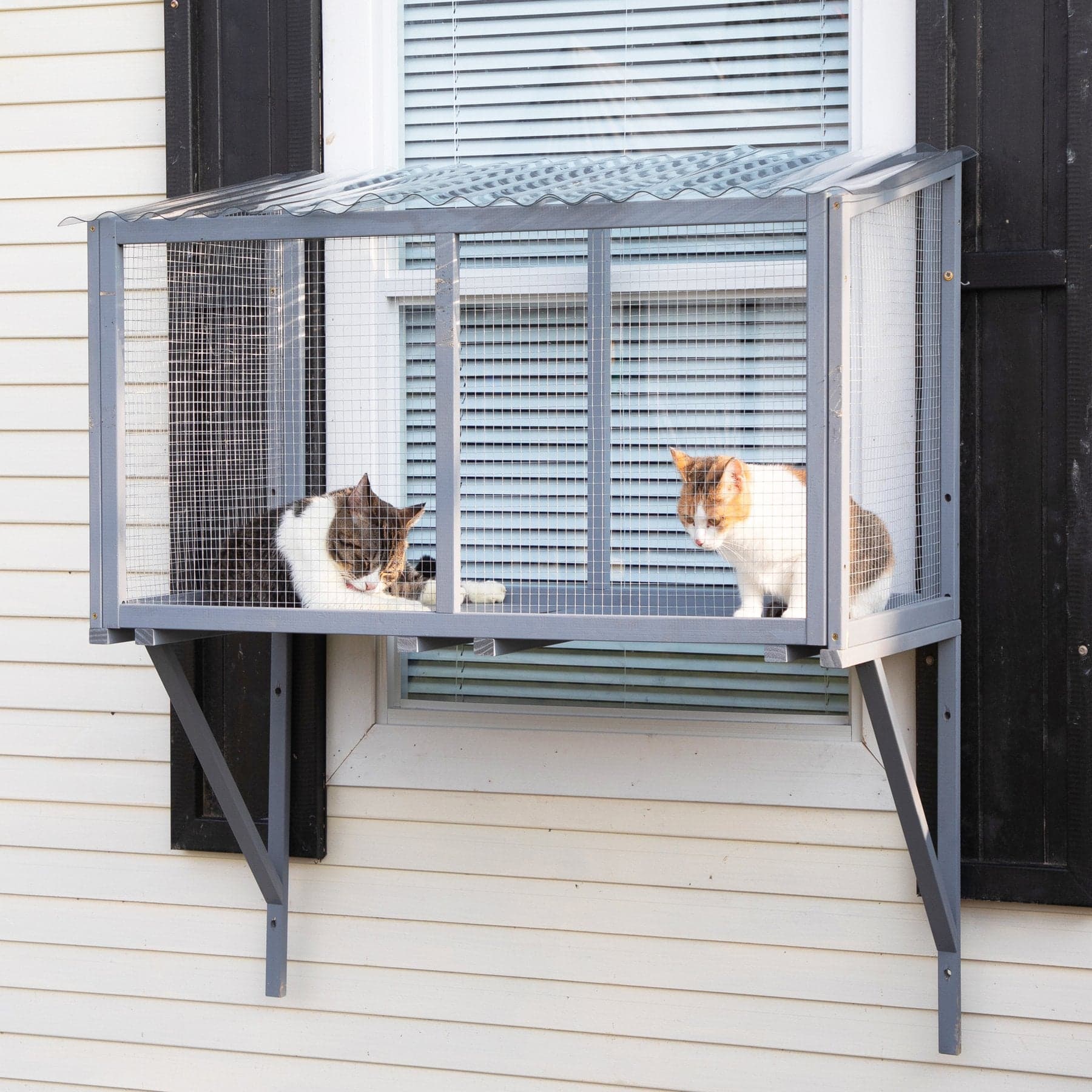 Coziwow gray window catio shown on exterior brackets beneath a window